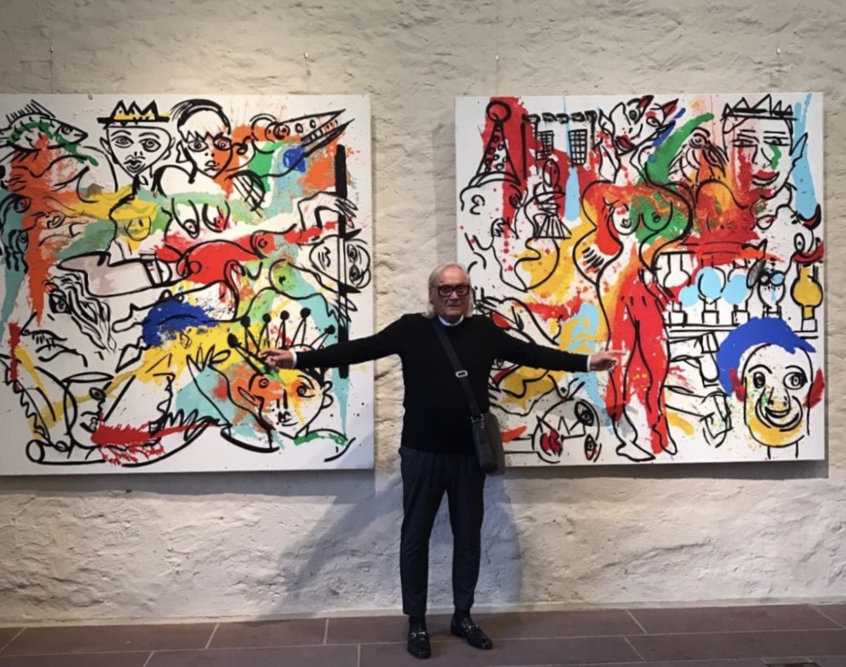 Peter Keil standing between two of his large original works